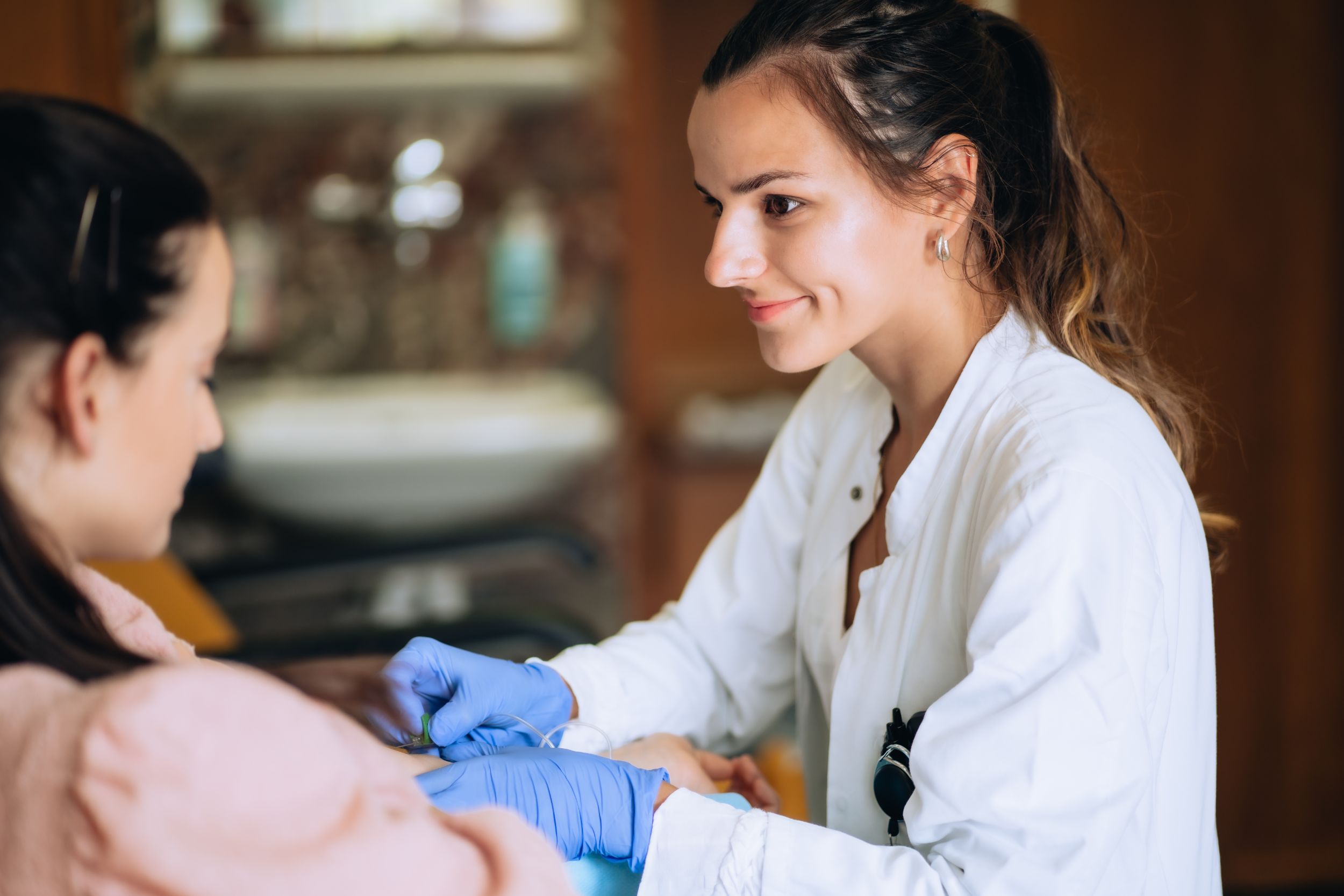 Doctor with blue gloves treats a patient