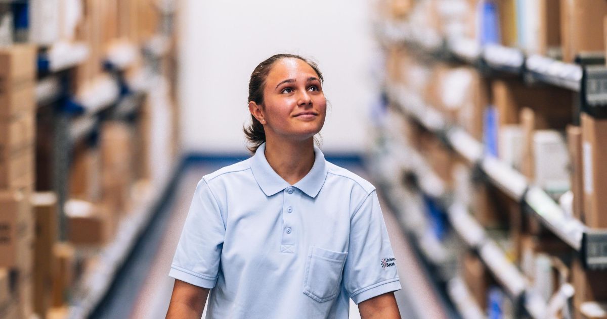 Trainee logistician runs through the warehouse