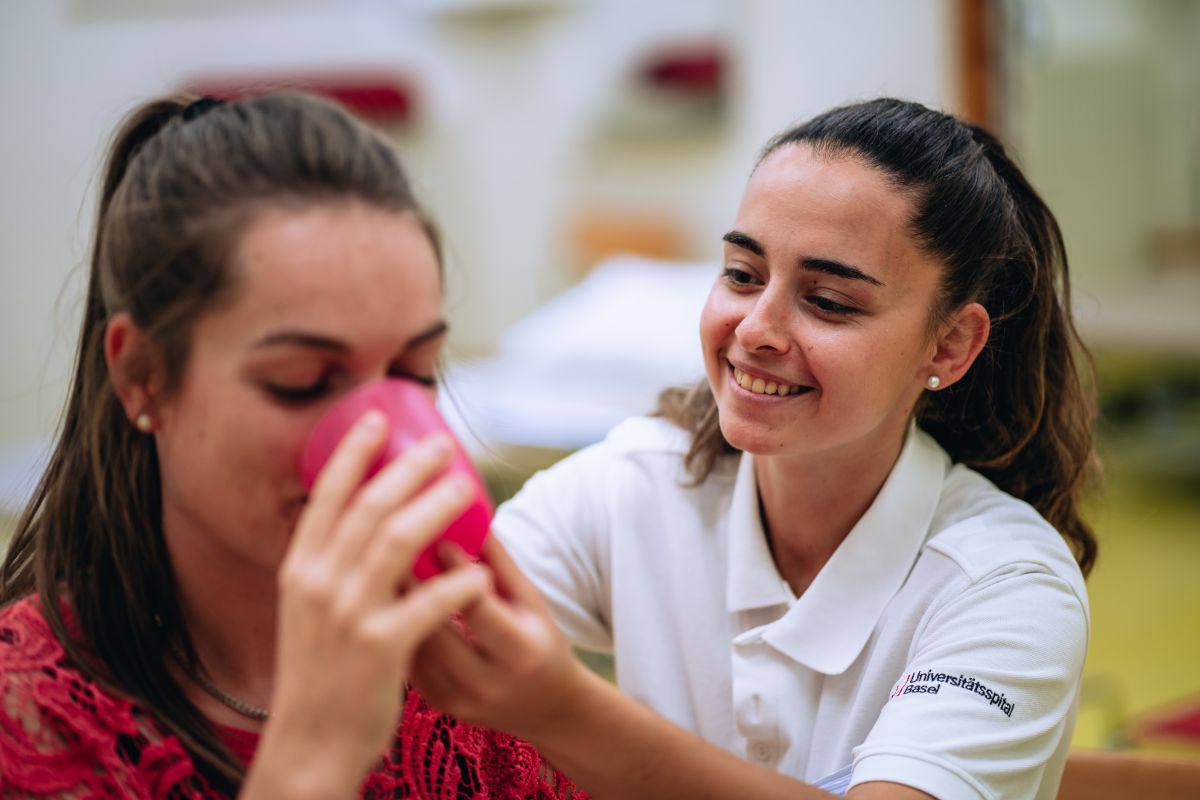 Speech therapist helps patient to drink